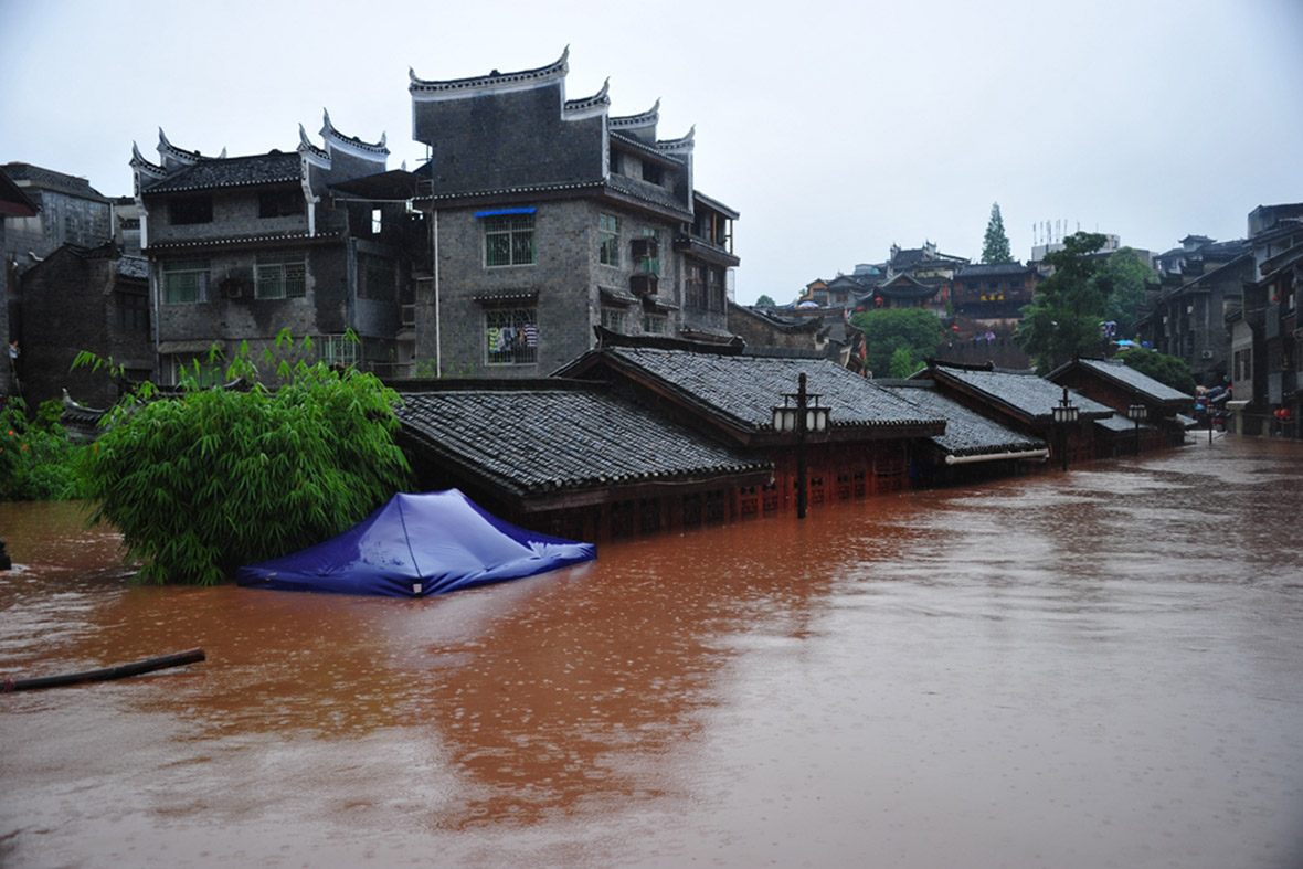 Buildings in the ancient town of Fenghuang are submerged in flood water. Getty