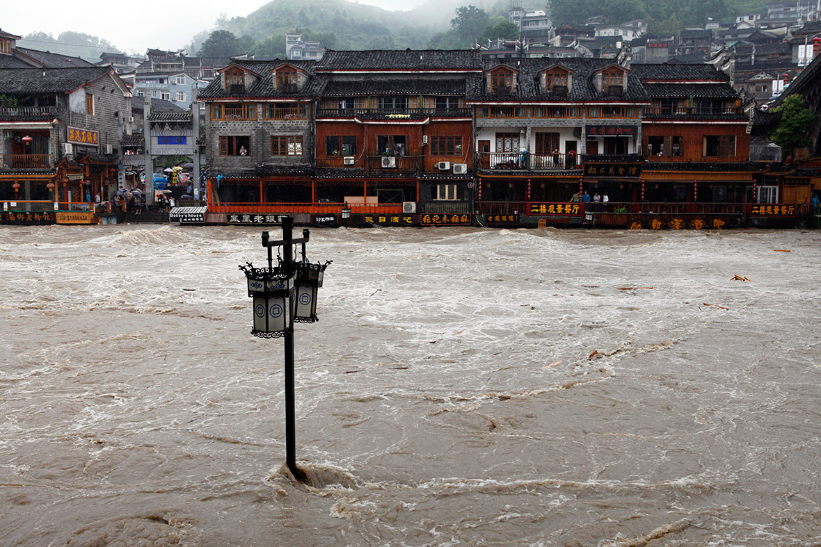 A street lamp is seen in the overflowing river. Reuters