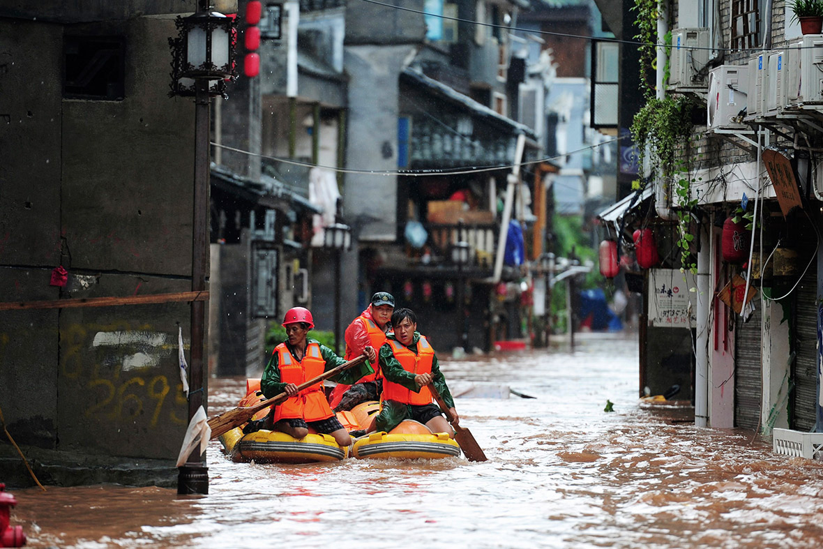 Rescue workers search for people on a flooded street. Reuters