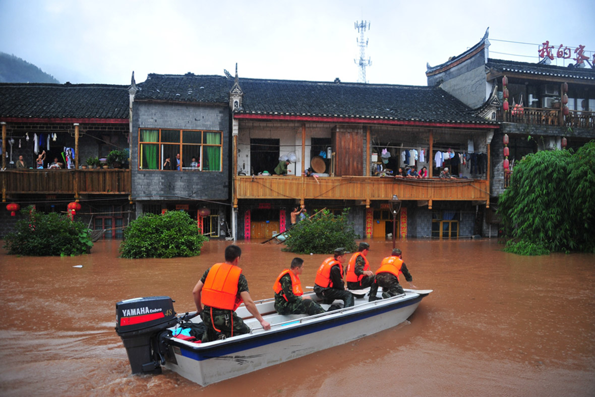 Rescuers use a boat to evacuate residents from flooded homes. Getty