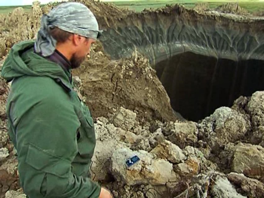A researcher examines the hole