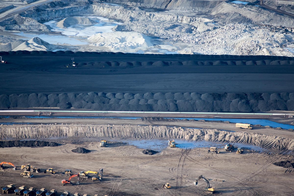 Suncor Oil Sands Project. Piles of uncovered petrolum coke, a byproduct of upgrading tar sands oil to synthetic crude. “Petcoke” is between 30-80 per cent more carbon intense than coal per unit of weight.